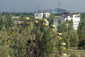 Abandoned fairground, with Chernobyl power plant in the background