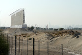 Billboard, sales center coaster and rocket against the backdrop of Dubai skyline