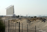 Billboard, sales center coaster and rocket against the backdrop of Dubai skyline