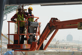 Ferrari World workers, with Al Raha Beach in the background