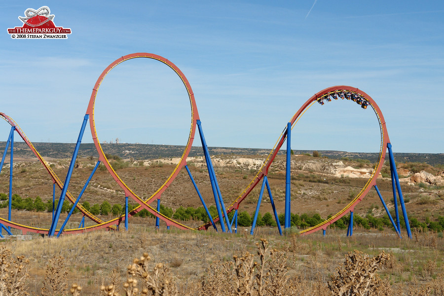 Huge looping roller coaster stretching beyond the park's borders