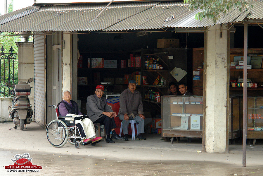 Locals sitting in a shop facing the Disneyland site