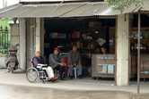 Locals sitting in a shop facing the Disneyland site