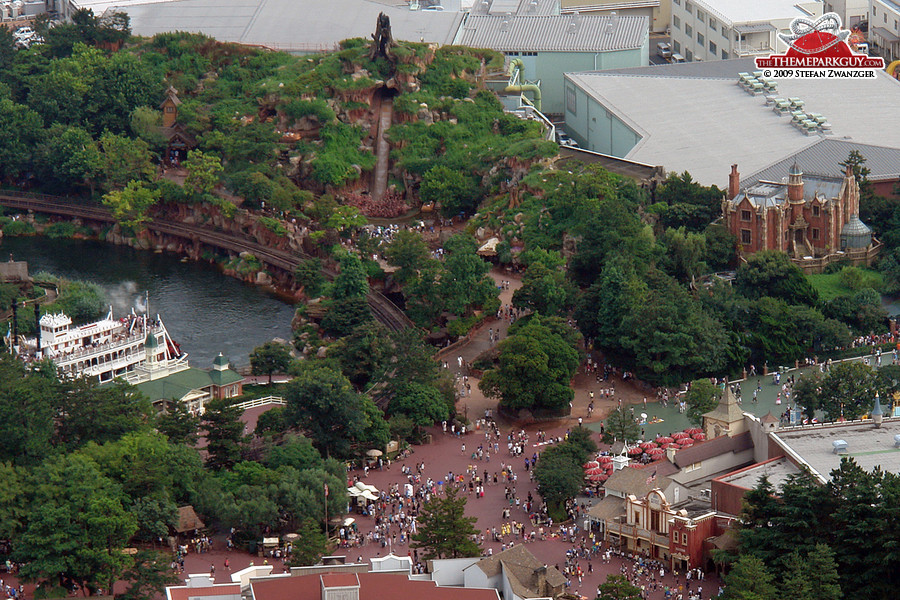 Splash Mountain flume ride on the left, Haunted Mansion ghost train on the right