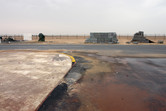 Flat, barren desert behind