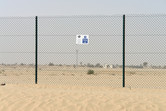 A little signboard on the fence