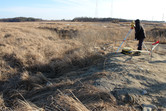 Technician surveying the dinosaur site