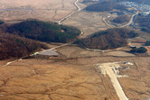 The end of road 77 on the left, the runway on the right