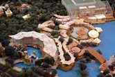 Model of the Waterworld show stadium and the adjacent Jurassic Park section