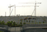 Ferrari World dueling coaster at the front, water park cranes at the back